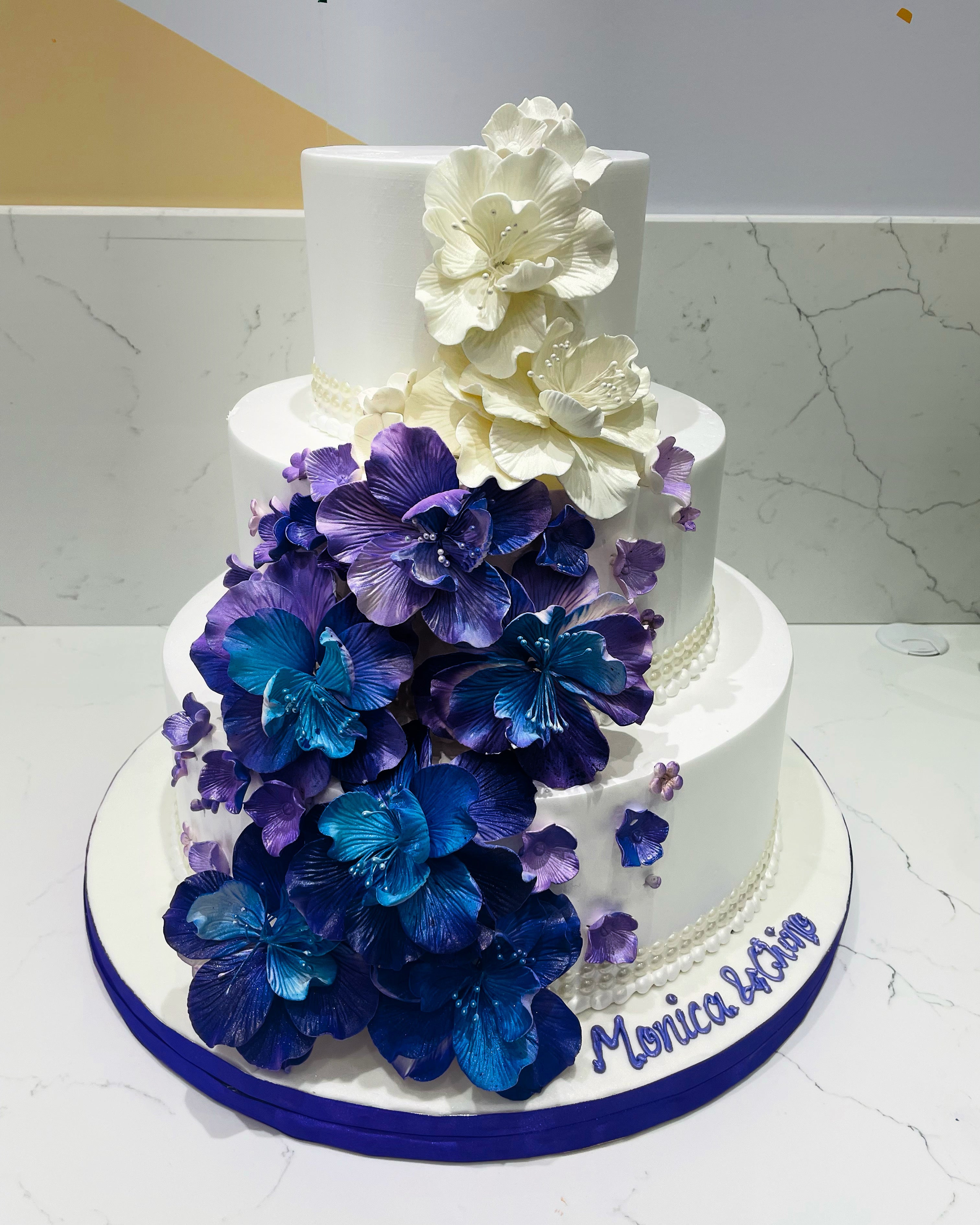 PURPLE & BLUE CASCADING FLOWERS WEDDING CAKE - Rashmi's Bakery